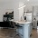 Spacious and well lit kitchen with wood flooring and stainless steel appliances