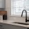Spacious and well lit kitchen with wood flooring and stainless steel appliances