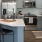 Spacious and well lit kitchen with wood flooring and stainless steel appliances