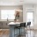 Spacious and well lit kitchen with wood flooring and stainless steel appliances